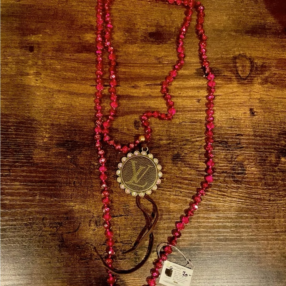 Beaded long pink necklace with leather fringe and a bling charm